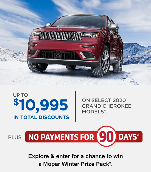 Image of red Jeep Grand Cherokee in wintry mountain scene.